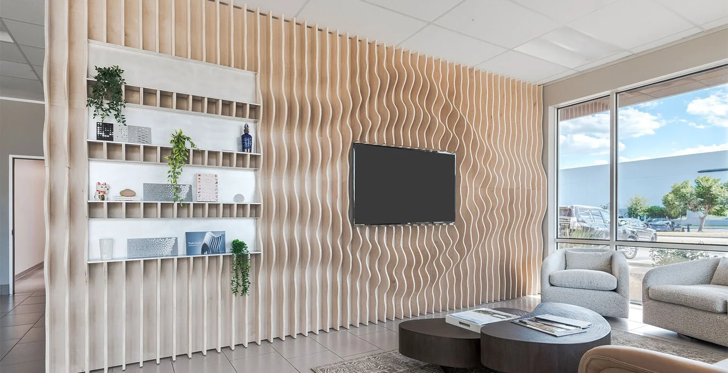 Modern office breakroom with warm wood and lounge seating.