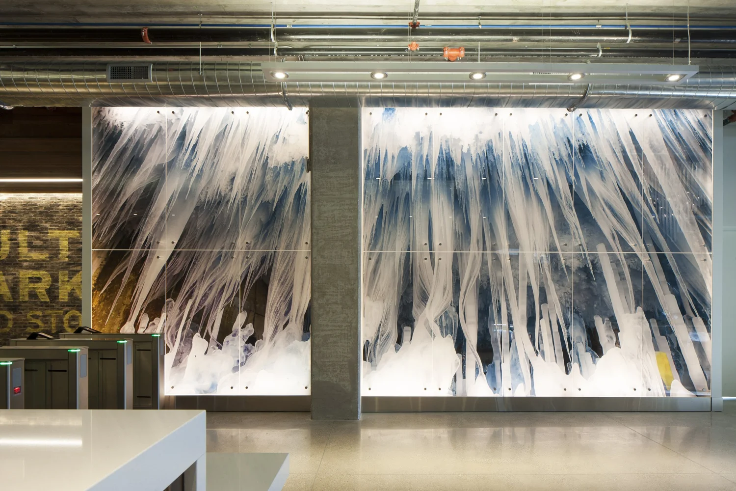 Abstract glass wall art installation in a commercial interior.